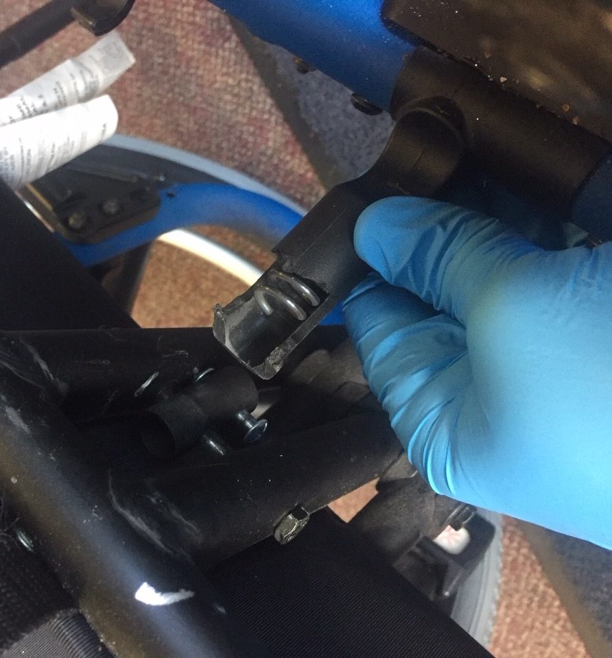 Tech inspecting broken wheelchair frame